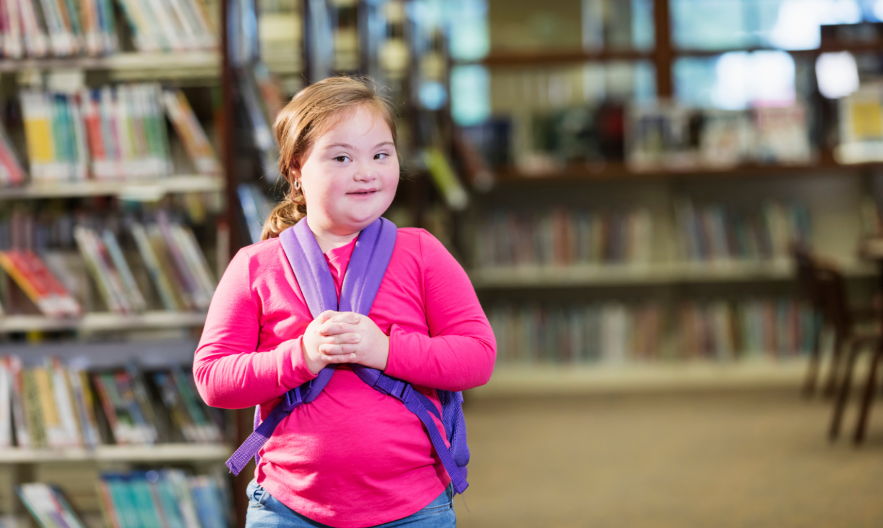 Girl with disability in a school library