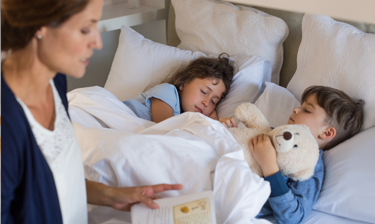 Parent reading story to children at bedtime