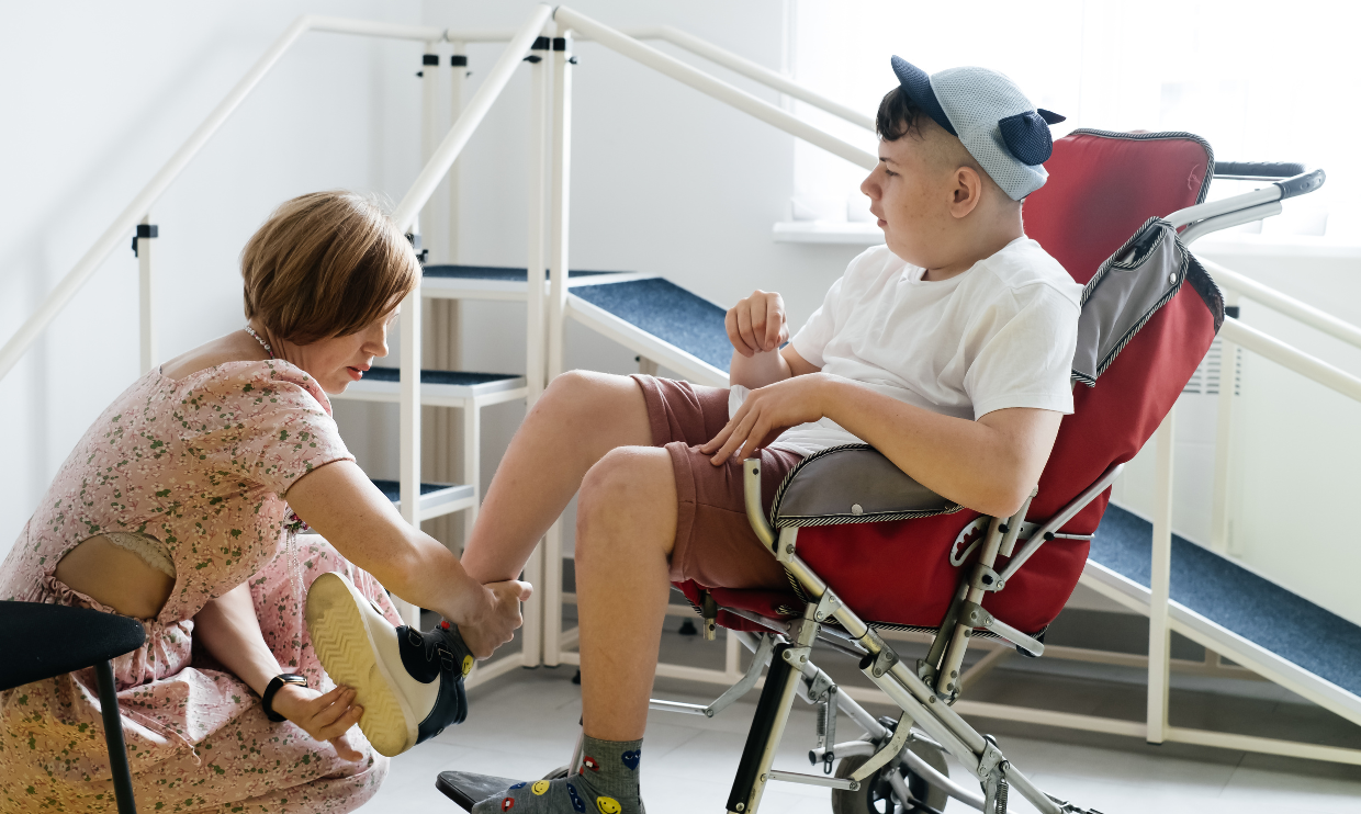 Woman helping teen with daily care