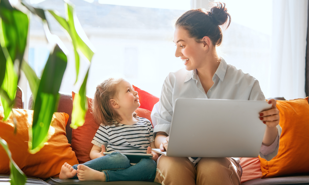 Parent on laptop looking at child